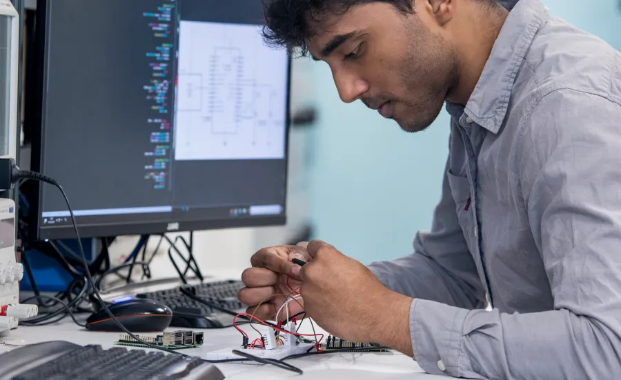 Male mobile secure system engineering student holding an electronic device