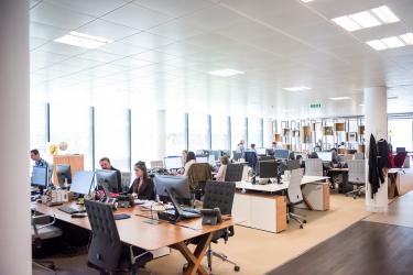 Image showing people working in a large office space.