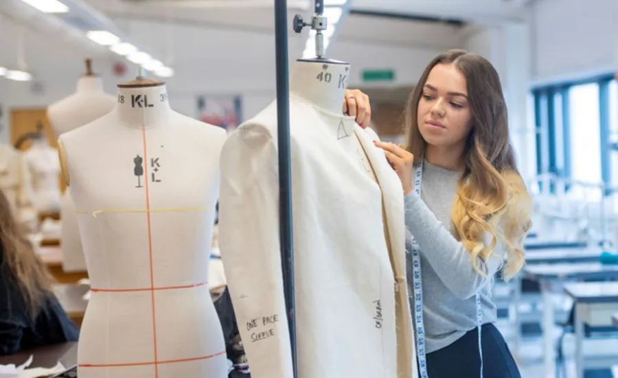 A fashion design student at work in the studio.