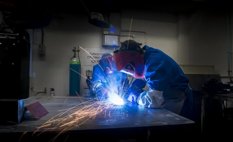 Students use welding equipment in the engineering design and manufacturing centre