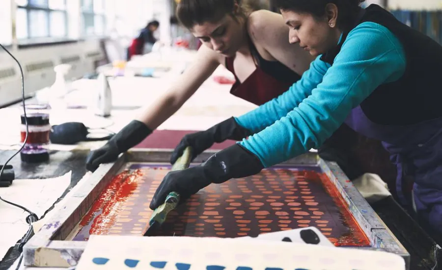Two students working on printed textiles.
