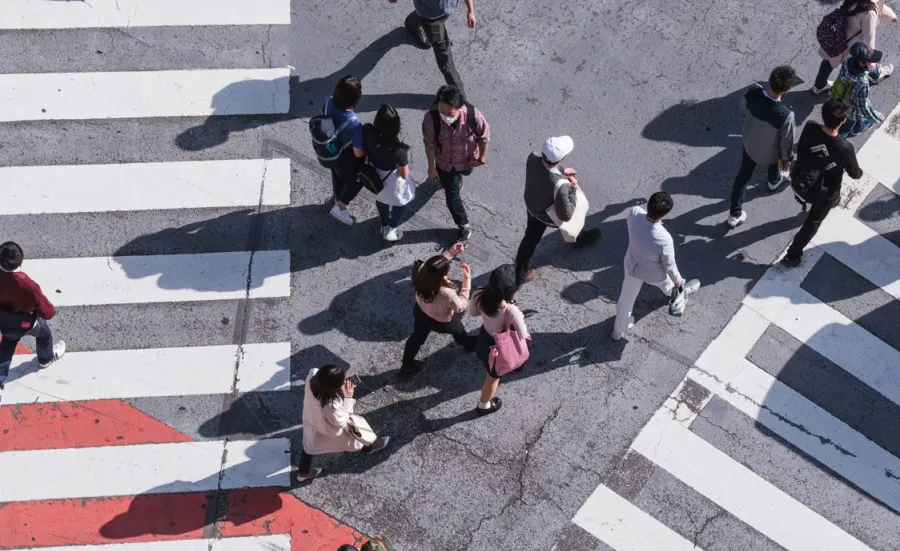 People crossing a busy pedestrian crossing