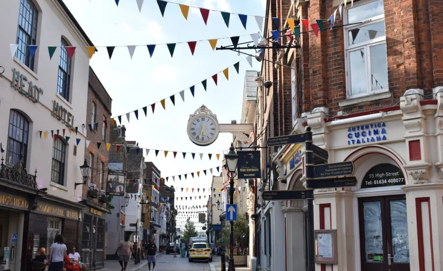 View of a typical UK town highstreet with shop fronts and bunting