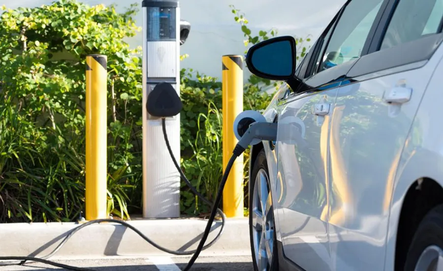 An electric car refuels at a charging point