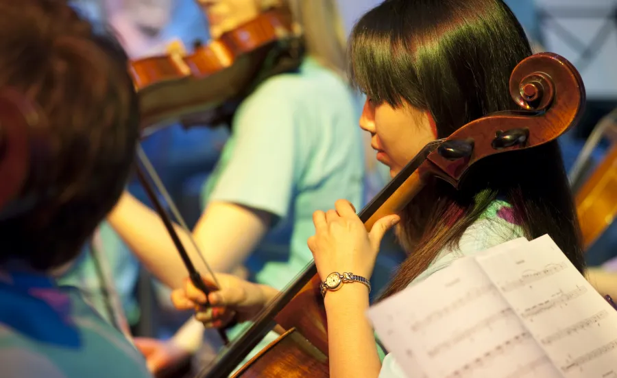 A student playing cello as part of the Southampton University Symphony Orchestra.