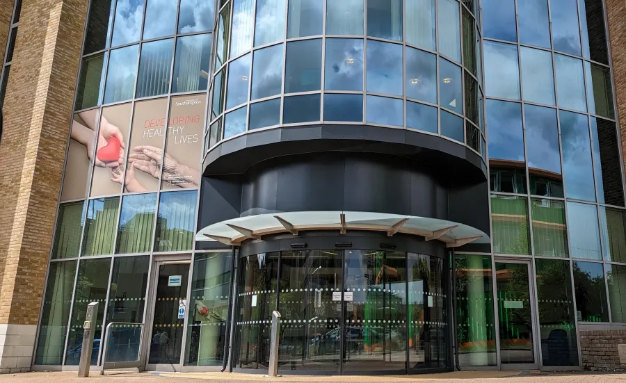 Exterior view of the modern glass-fronted building that houses the Institute of Developmental Sciences.