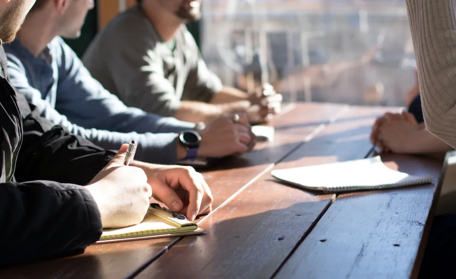 People round a table in a meeting