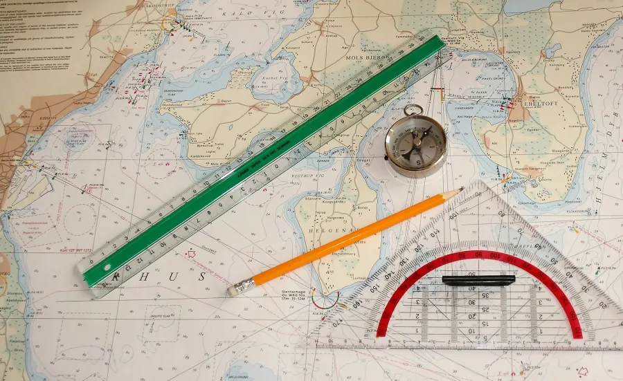 Nautical chart with a pencil, ruler and compass on it