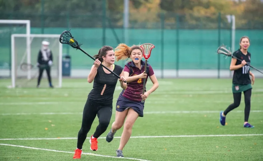 Students playing lacrosse at Wide Lane Sports Ground