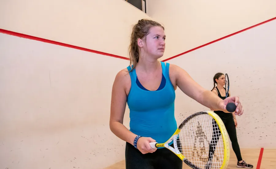 Two female students playing squash