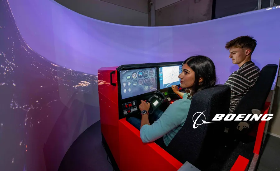Two students use the Boeing flight simulator