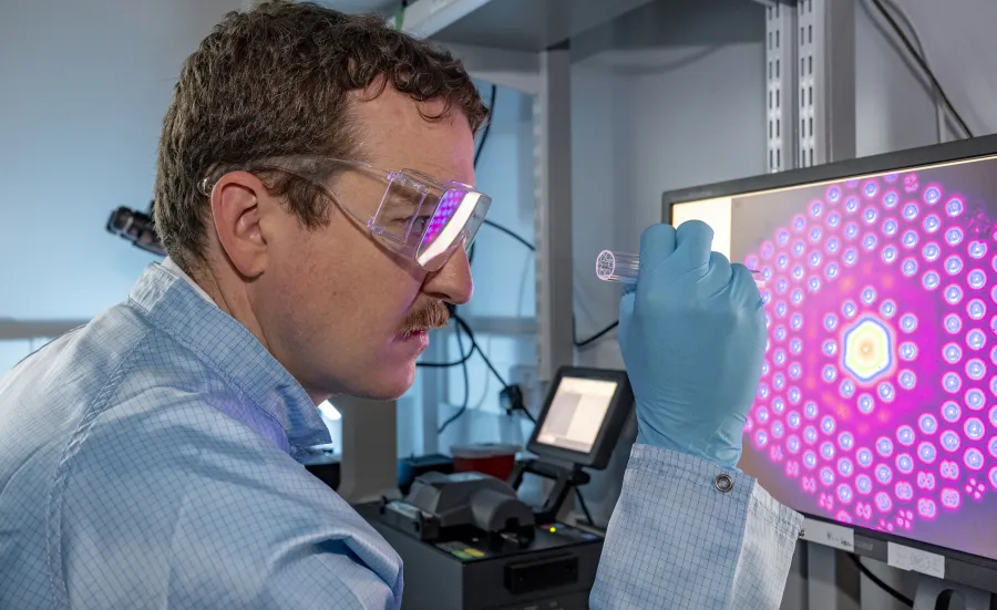 A man arranging microstructured fibre inspection