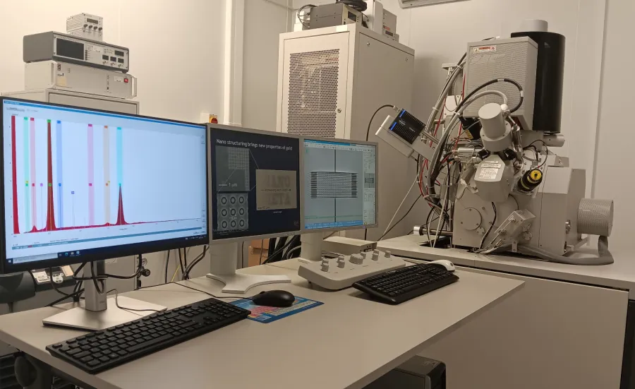 Focus Ion Beam (FIB) Facility. The image shows three screens with data displayed. There is lab equipment in the background.