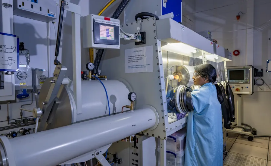 A woman near CVD Glovebox with Furnace  