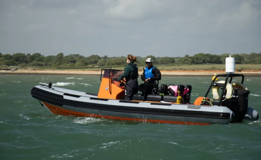 An instructor and student in a powerboat 