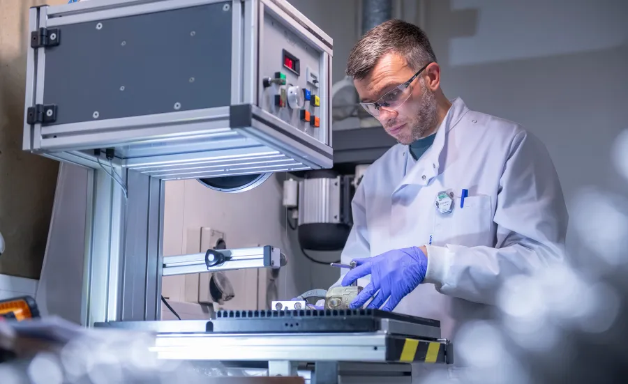 Scientist carrying out experiment using the facilities equipment