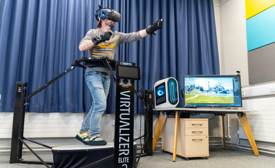 A person is using a VR treadmill to explore a virtual environment