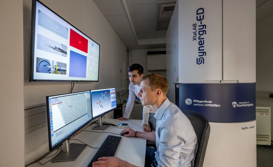 Two chemical technicians reviewing Electron Diffraction data on a computer screen at the NEDF facility