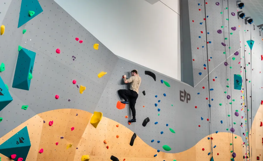 A climber climbing up Southampton University's indoor climbing wall