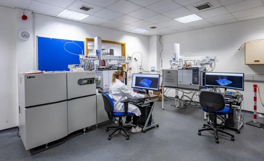 A woman researcher sat in front of a computer screen in a Chromatography-Mass Spectrometry laboratory