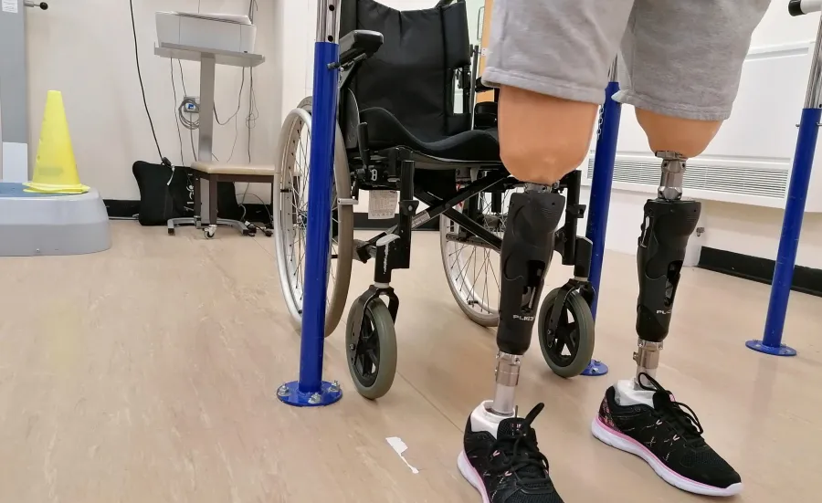 Patient wearing prostehtics infront of wheelchair