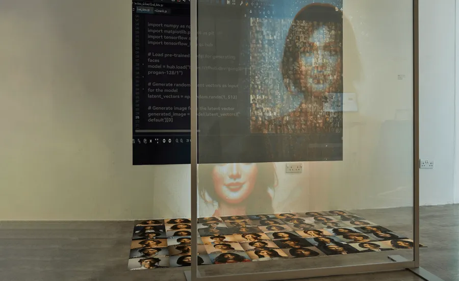 A multimedia installation at an exhibition, including photographs and projections of people.