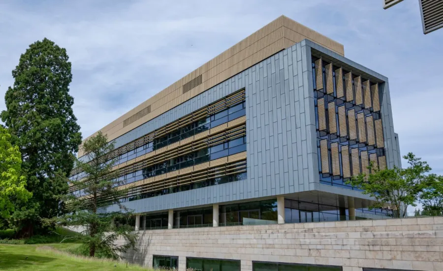 An external shot of Southampton Business School on the Boldrewood Innovation Campus at the University of Southampton. The modern building is surrounded by green space and trees.