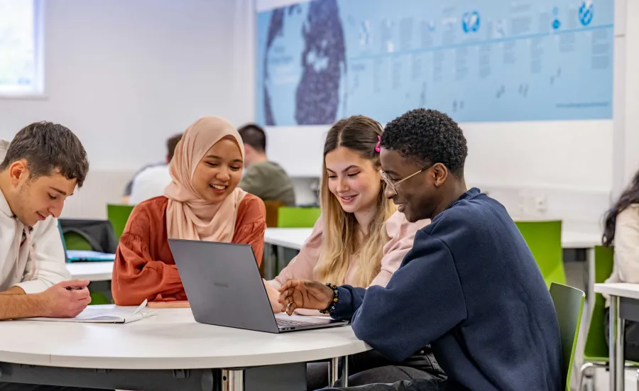 Students gathered round a laptop