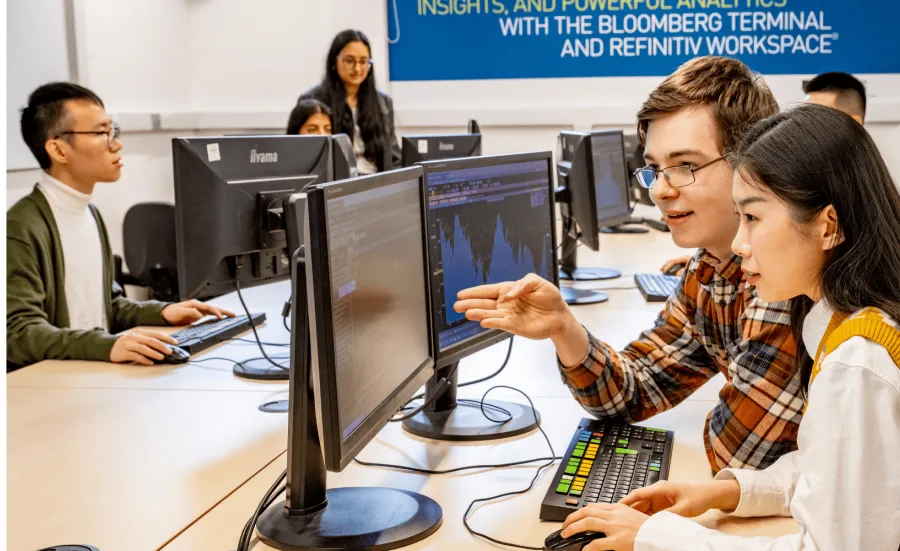 Two students sharing a desktop computer