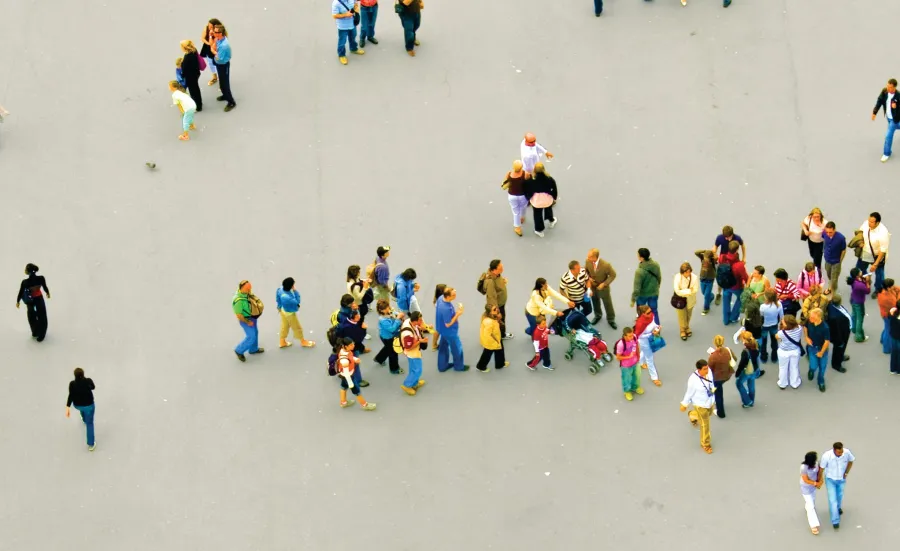 Birds eye view of numerous people milling around a piazza