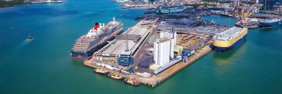 Aerial shot of cruise and cargo ships at a Southampton seaport with a vibrant sea