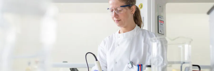 Scientist looking down and working with lab equipment