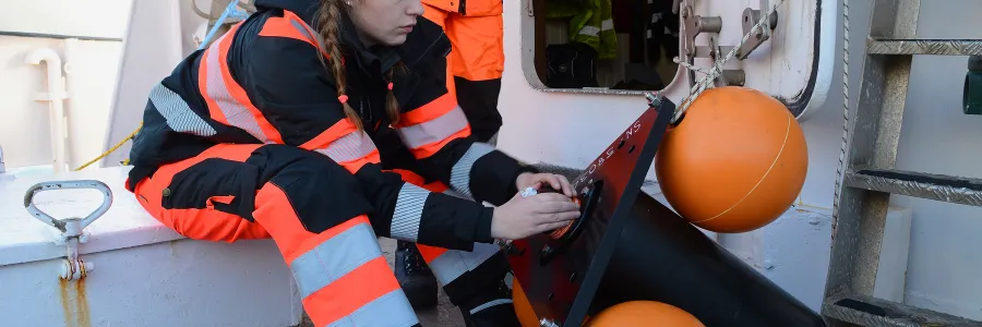 Researcher on boat preparing hydrophone for acoustic surveys of marine mammals in the Antartic