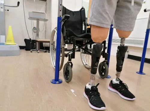 Patient wearing prostehtics infront of wheelchair