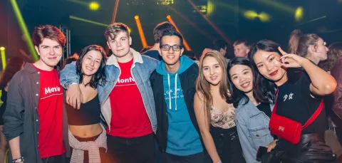 Group of happy fresher students at a nightclub.