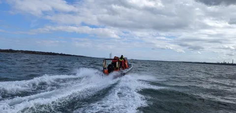 Powerboat speeding away from the camera