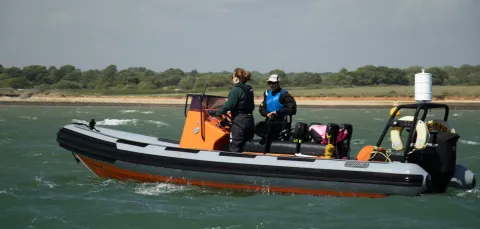 An instructor and student in a powerboat 