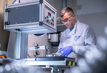 Scientist carrying out experiment using the facilities equipment