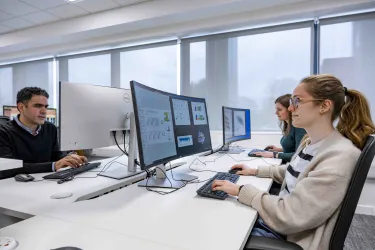 Students undertaking work at a computer station. 