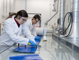 Two students at work in the testing and structures research lab