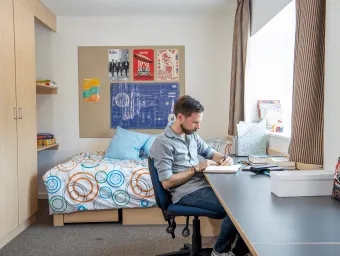 A student sitting in his studio flat.