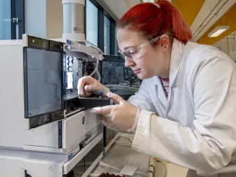 Chemistry researcher uses equipment in a specialist laboratory