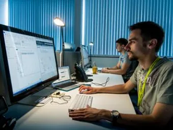 A man performs research seated at a computer.