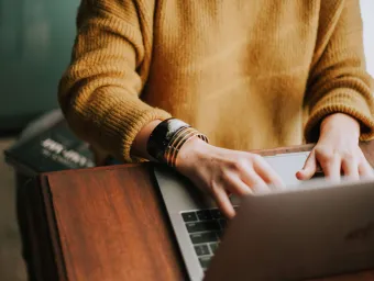 hands on a laptop