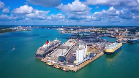 Aerial shot of cruise and cargo ships at a Southampton seaport with a vibrant sea