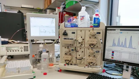 View of a bench with protein analysis equipment and computer screen showing results