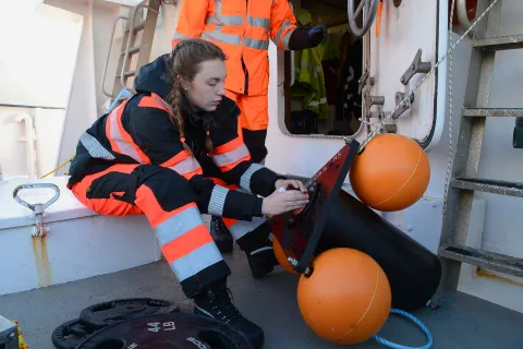 Researcher on boat preparing hydrophone for acoustic surveys of marine mammals in the Antartic