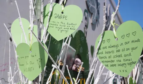 Green paper hearts with mesaages of rememberance for Grenfell Tower victims hearts with 