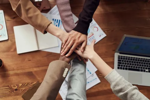 Photo of people hands near wooden table