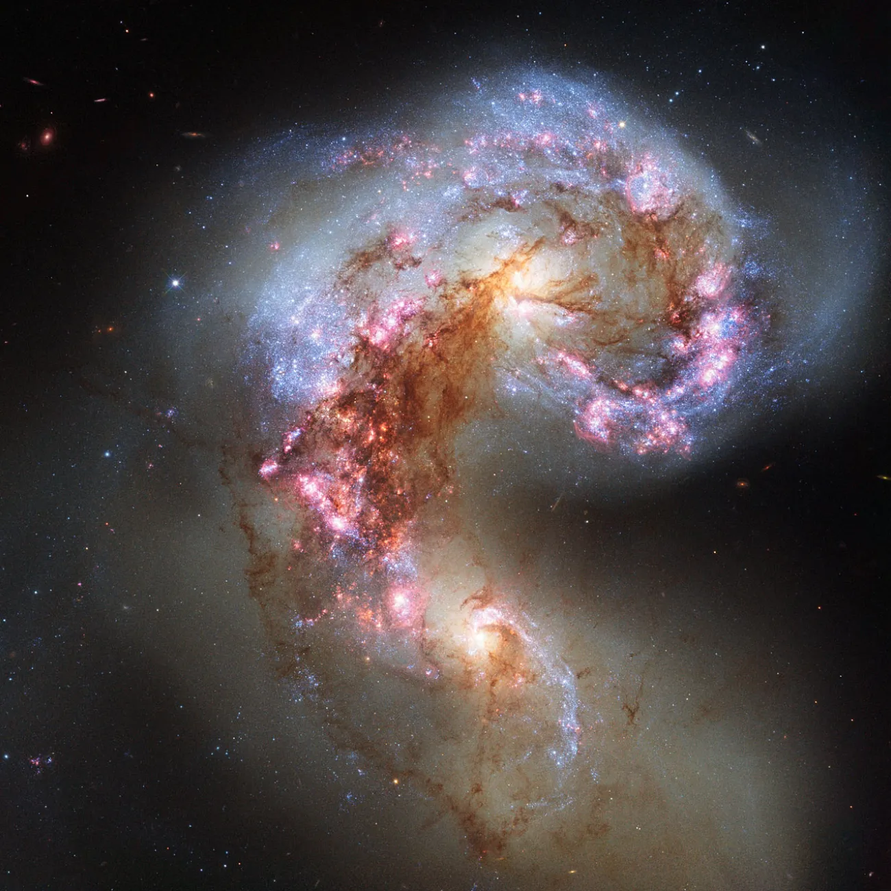 A satellite image of two galaxies merging and creating a new group of stars.